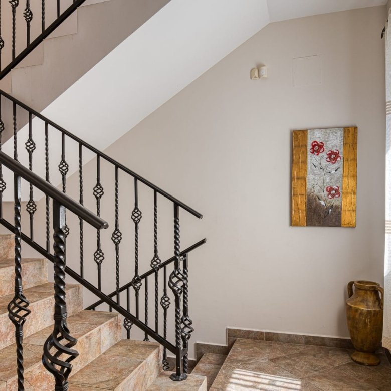 Elegant staircase with designer iron railings, sunlit windows, and tasteful decor&mdash;ideal Ulcinj investment. Montenegro-listings.me by ekosphere doo.
