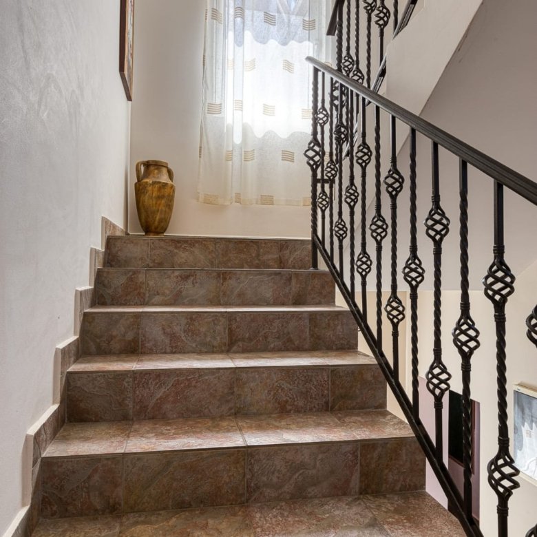 Elegant tiled staircase with modern railings, natural light, and upscale d&eacute;cor&mdash;prime Ulcinj real estate by immorenta.me.