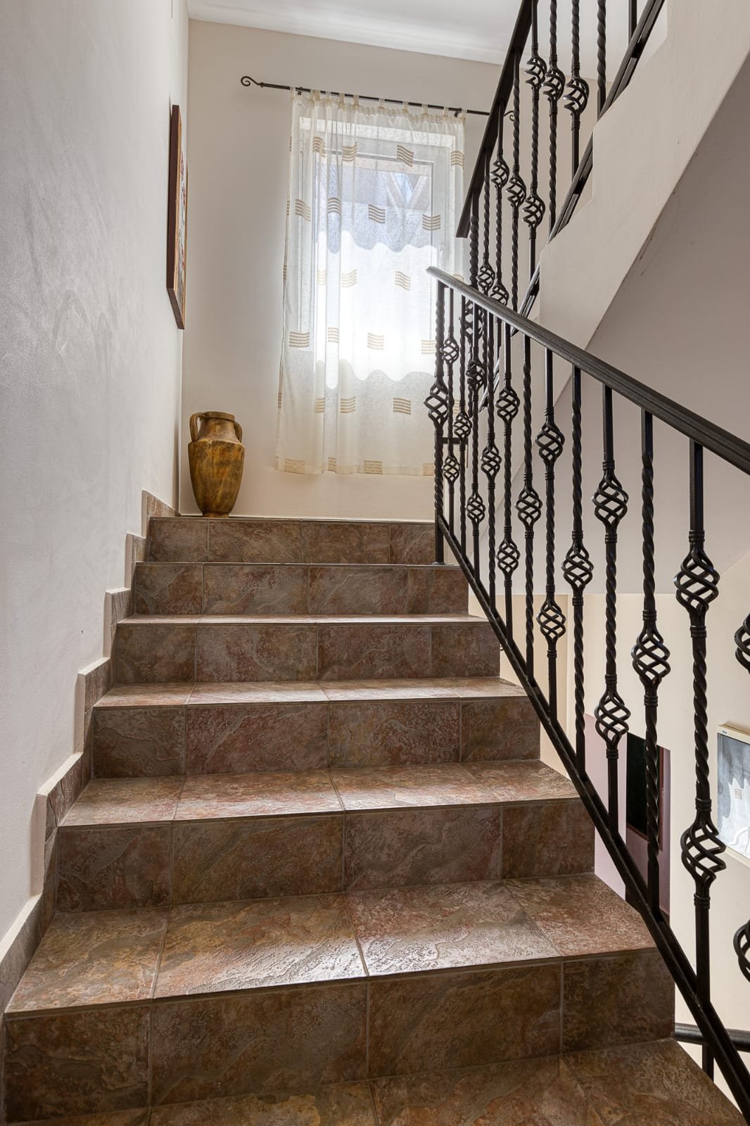 Elegant tiled staircase with modern railings, natural light, and upscale d&eacute;cor&mdash;prime Ulcinj real estate by immorenta.me.