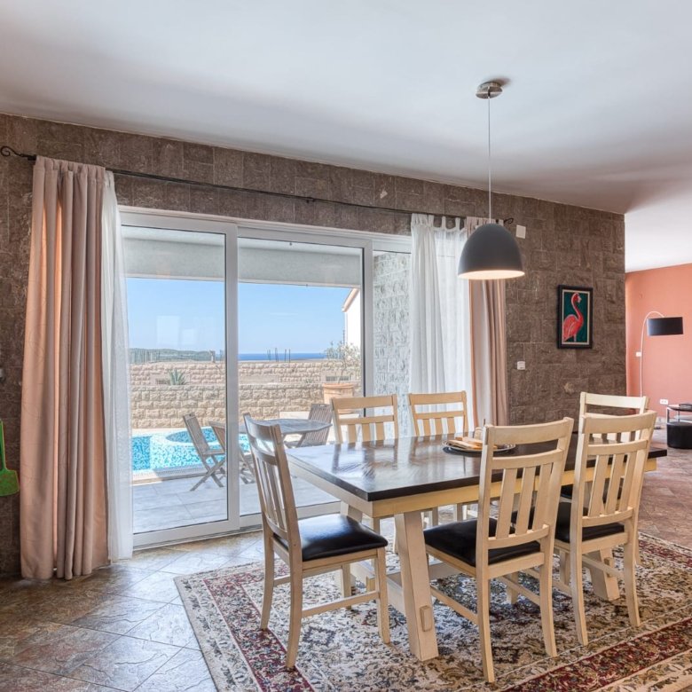Elegant dining area with stone walls, pool views, and open-plan living&mdash;prime Ulcinj property via immorenta.me by ekosphere doo.
