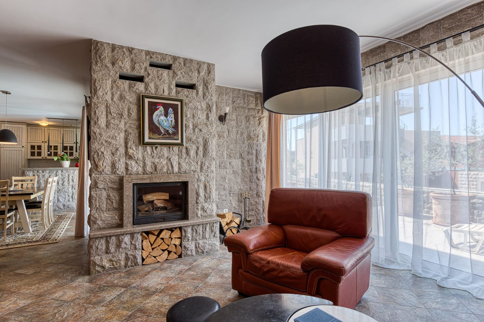 Elegant Ulcinj living room: stone fireplace, large windows, premium finishes. Exclusive on immorenta.me by ekosphere doo.