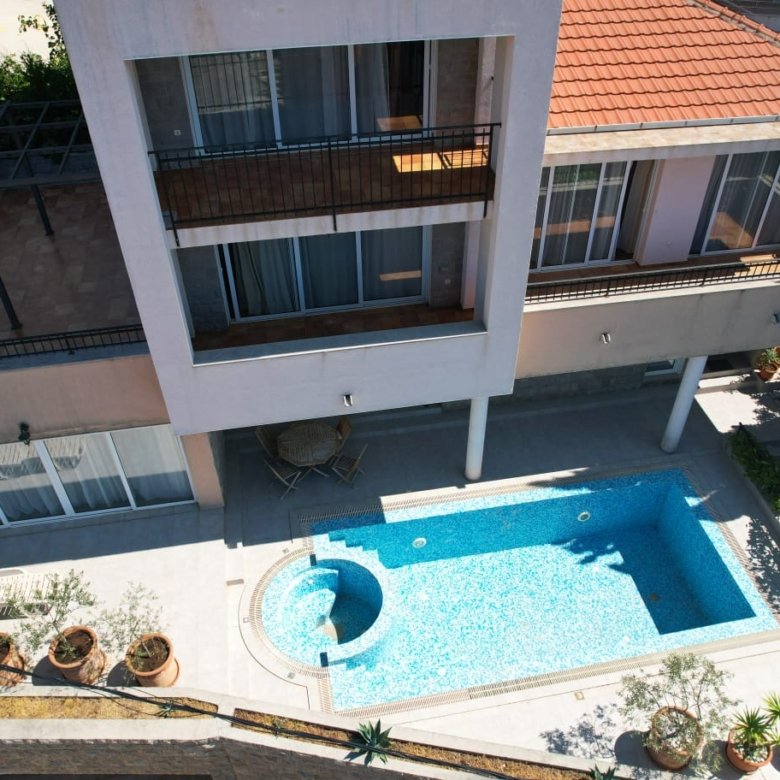 Stunning modern home in Ulcinj, Montenegro: tiled roof, large windows, balcony, pool & patio. Exclusive on immorenta.me by ekosphere doo.