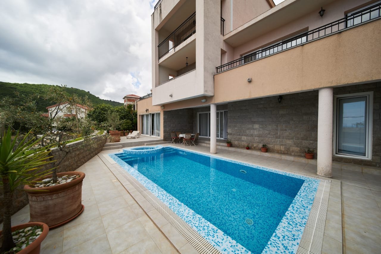 Luxury residential property in Ulcinj with pool, balconies, potted plants, and hill views&mdash;exclusive at immorenta.me by ekosphere doo.
