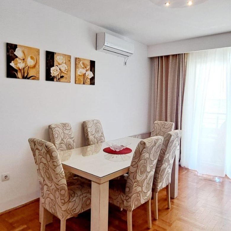 Bright Ulcinj dining room with modern white table, six stylish chairs, AC, natural light&mdash;exclusive at immorenta.me (ekosphere doo).