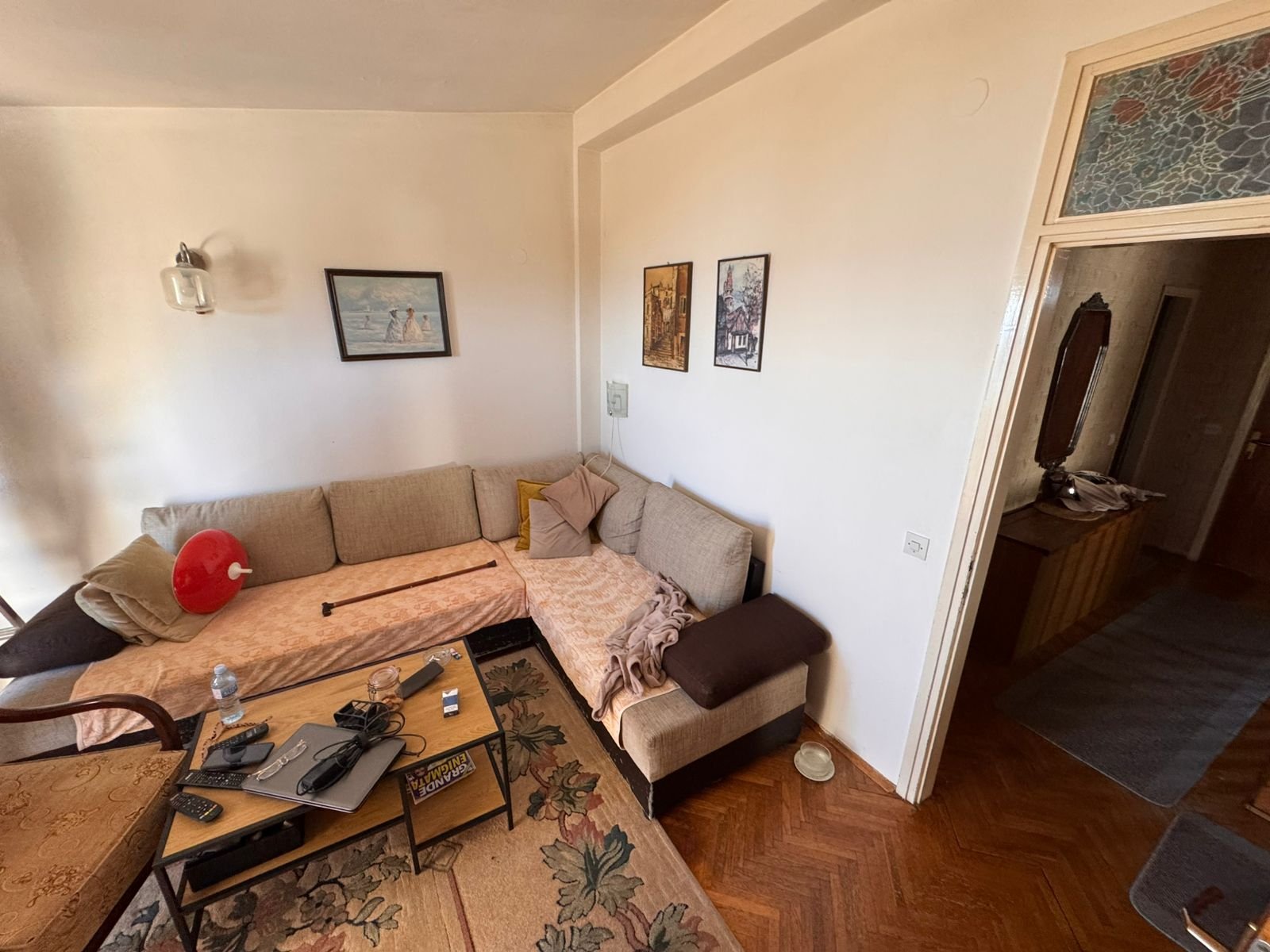 Elegant Ulcinj living room with modern corner sofa, stylish d&eacute;cor, and hallway; ideal Montenegro investment at immorenta.me.