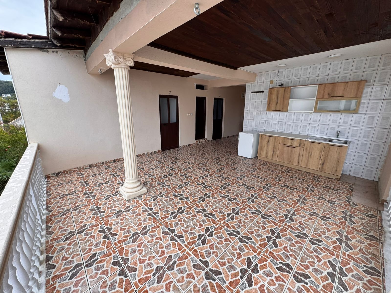 Stylish covered terrace in Ulcinj, Montenegro&mdash;patterned tiles, wooden ceiling, kitchenette. Prime investment via immorenta.me.