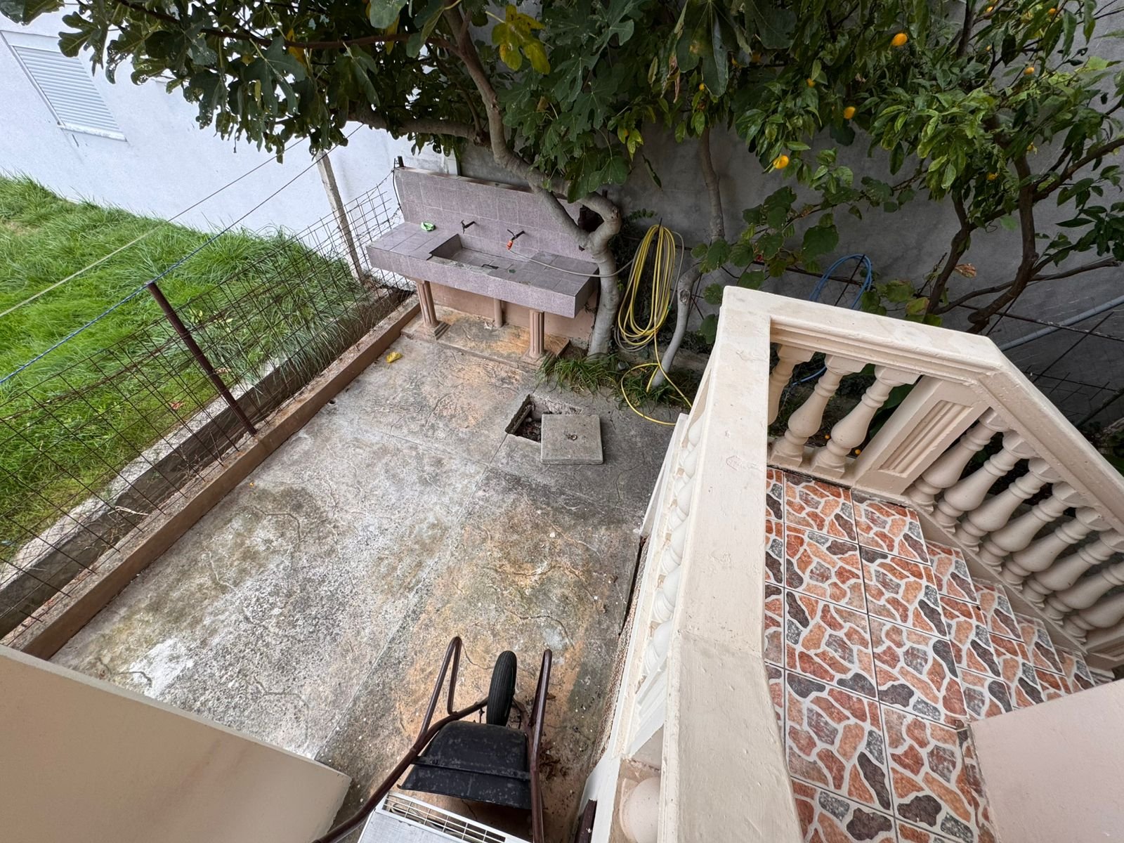 Spacious concrete backyard with tiled staircase, tree, utility sink&mdash;ideal Ulcinj investment via immorenta.me by ekosphere doo.