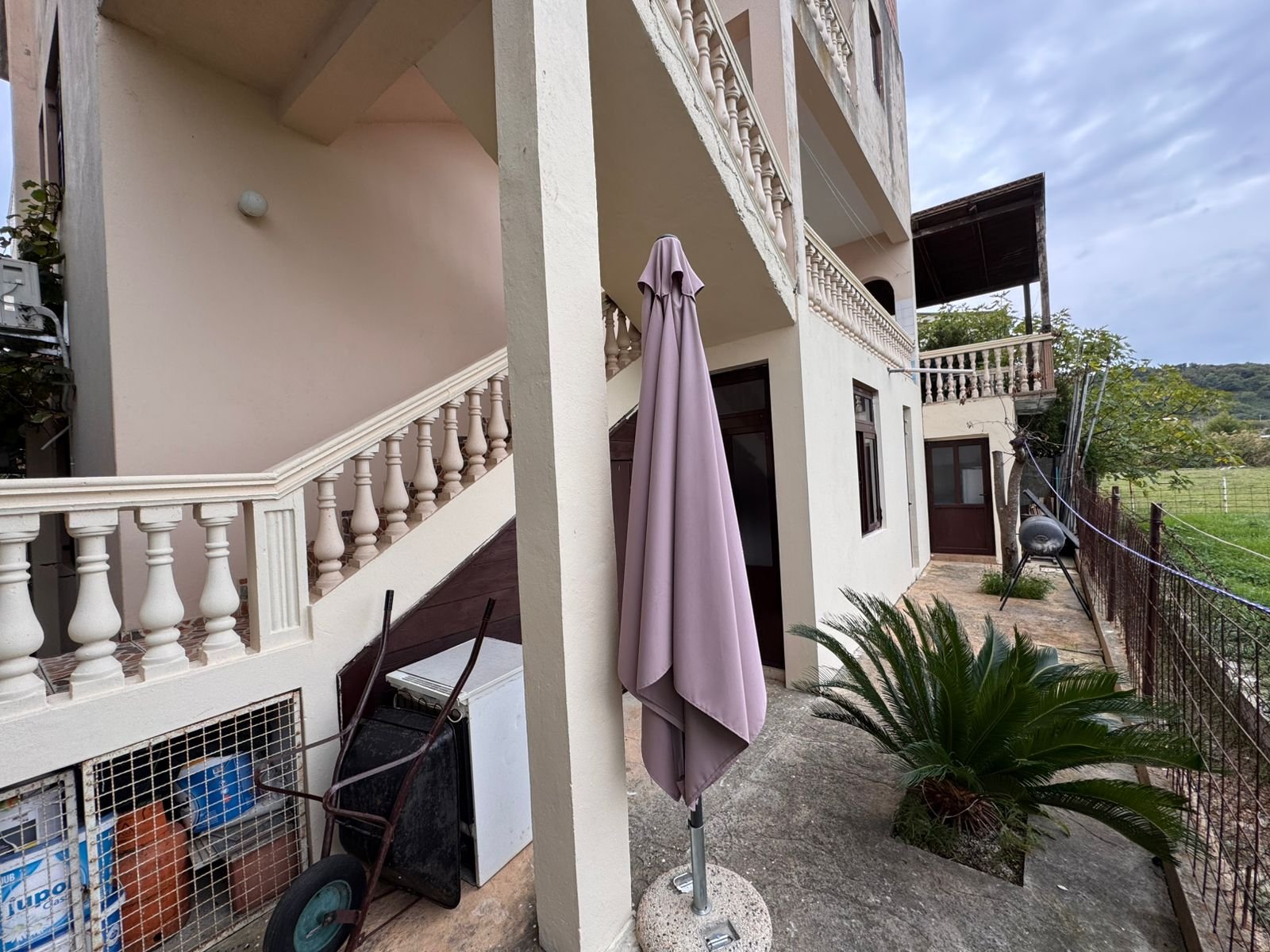 Modern beige two-story home in Ulcinj, Montenegro with private patio and garden, ideal for investment; listed on immorenta.me.