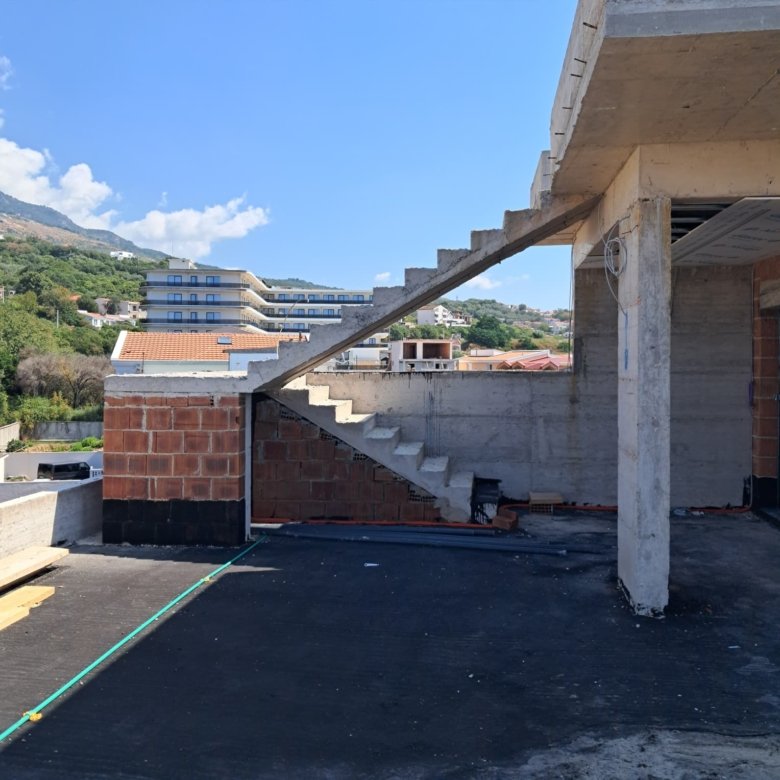 Prime Ulcinj investment: unfinished property with concrete stairs, exposed brick, scenic views. Listed by immorenta.me/Ekosphere DOO.