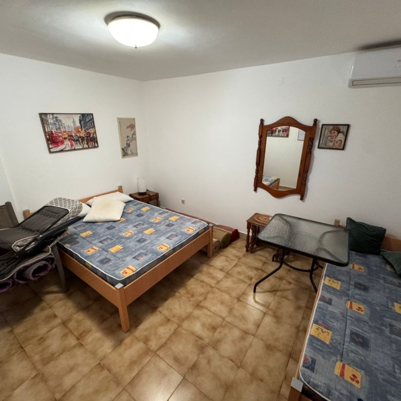 Charming tiled bedroom in Ulcinj with double and single beds, AC, elegant furnishings&mdash;ideal Montenegro real estate investment, by ekosphere doo.