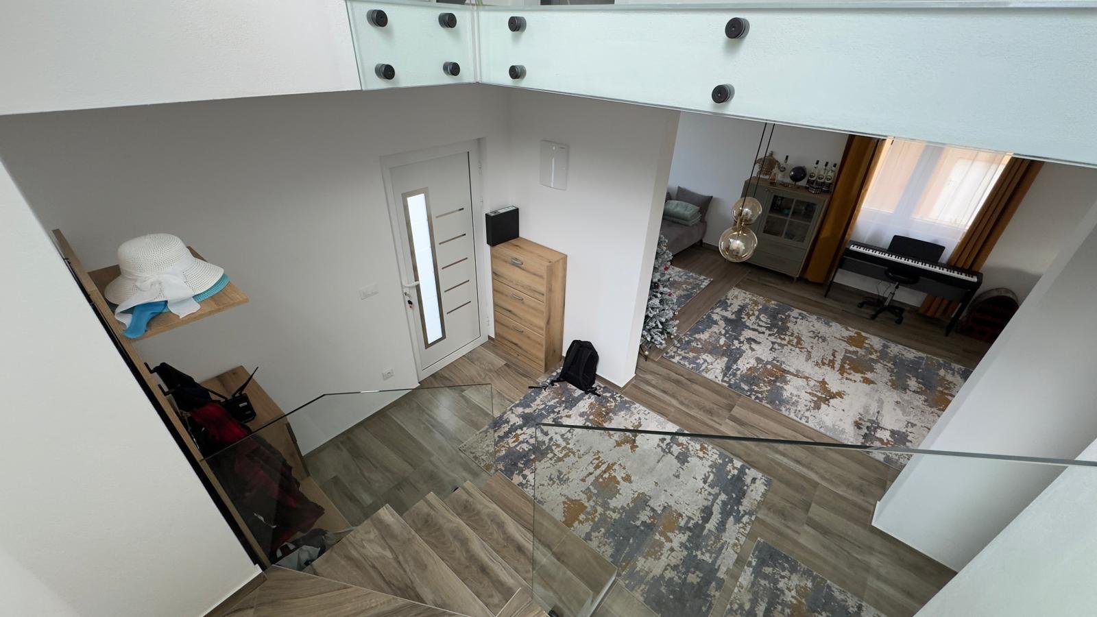 Stylish Ulcinj home with modern glass stairwell, elegant entry, bright living area, and piano&mdash;prime investment at immorenta.me.