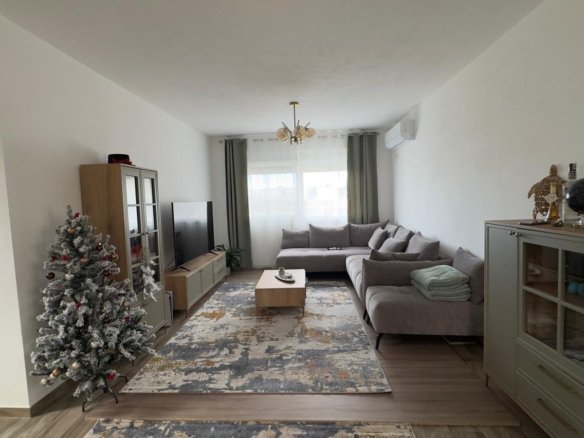 Stunning Ulcinj apartment: modern living room, gray sectional sofa, large windows, stylish decor. Exclusive at immorenta.me by ekosphere doo.