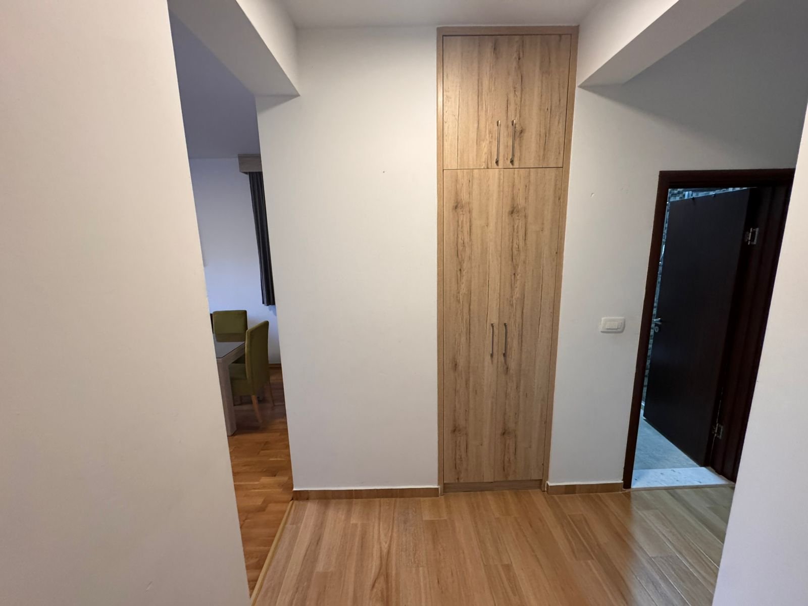 Bright hallway with modern wood flooring, quality storage, and access to stylish dining&mdash;Prime Ulcinj property at immorenta.me.