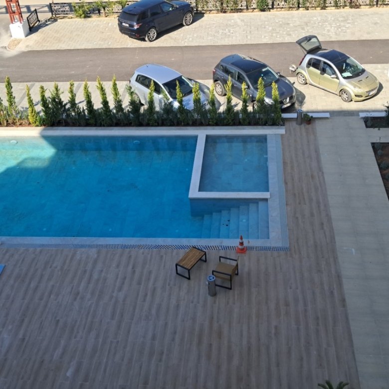 Luxury Ulcinj real estate: tiled patio, twin pools, stylish seating. Secure parking & privacy. immorenta.me by ekosphere doo.