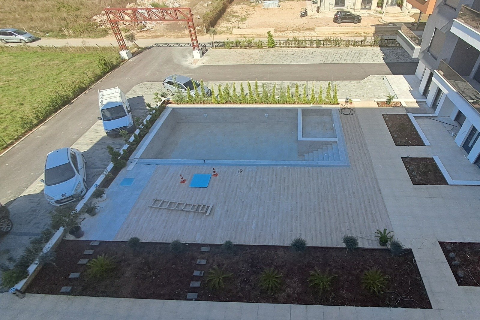 Spacious paved courtyard with rectangular pool, decorative greenery; excellent Ulcinj real estate from immorenta.me by ekosphere doo.