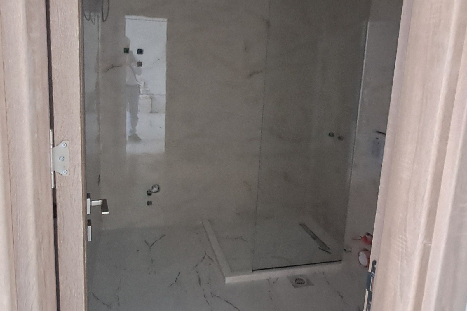 Modern bathroom in progress with elegant marble-style finishes and walk-in shower&mdash;prime Ulcinj investment at immorenta.me.