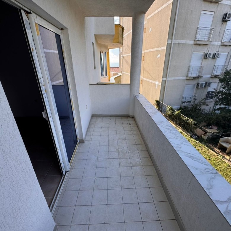 Spacious tiled balcony with marble railing, sliding glass door, city views&mdash;prime Ulcinj real estate by immorenta.me/Ekosphere doo.