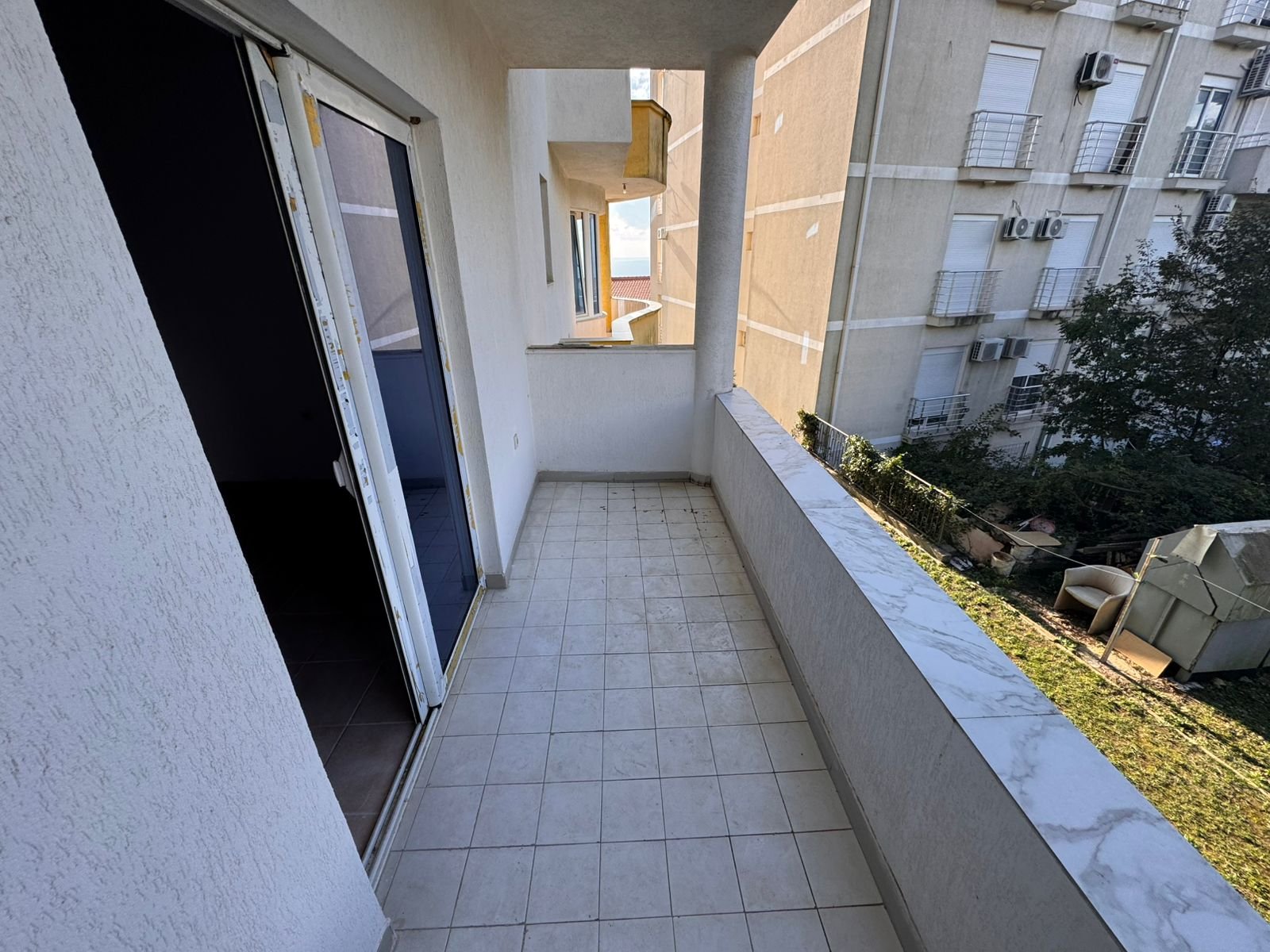 Spacious tiled balcony with marble railing, sliding glass door, city views&mdash;prime Ulcinj real estate by immorenta.me/Ekosphere doo.