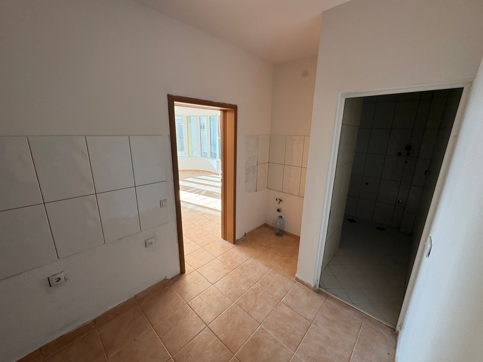 Bright, modern tiled space with beige floors, large sunlit windows; ideal Ulcinj investment on immorenta.me by ekosphere doo.