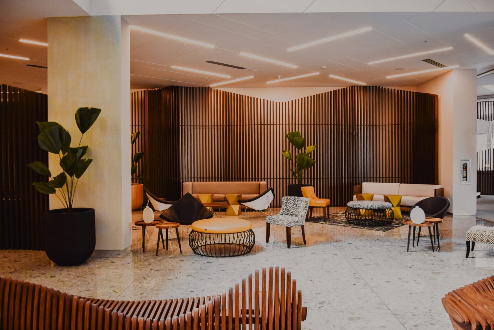 All Listings for Ulcinj 13 All Listings - Elegant lobby in Ulcinj with stylish sofas, terrazzo floors, wood panels—prime real estate via immorenta.me by ekosphere doo.