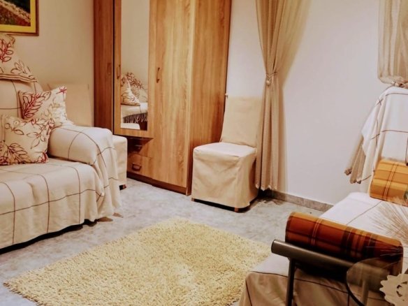 Bright, stylish Ulcinj living room with tile floors, beige sofas, and modern furnishings&mdash;prime investment on immorenta.me.