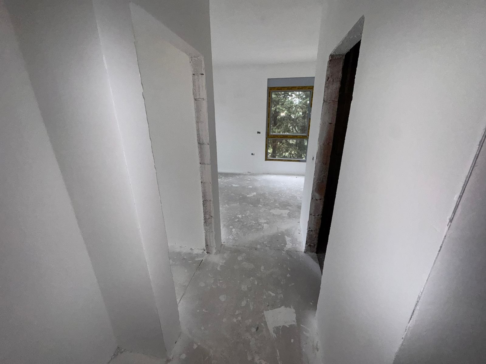 Spacious Ulcinj property with unfinished interiors, concrete floors, and large window views&mdash;ideal for investors. Eksophere doo project.